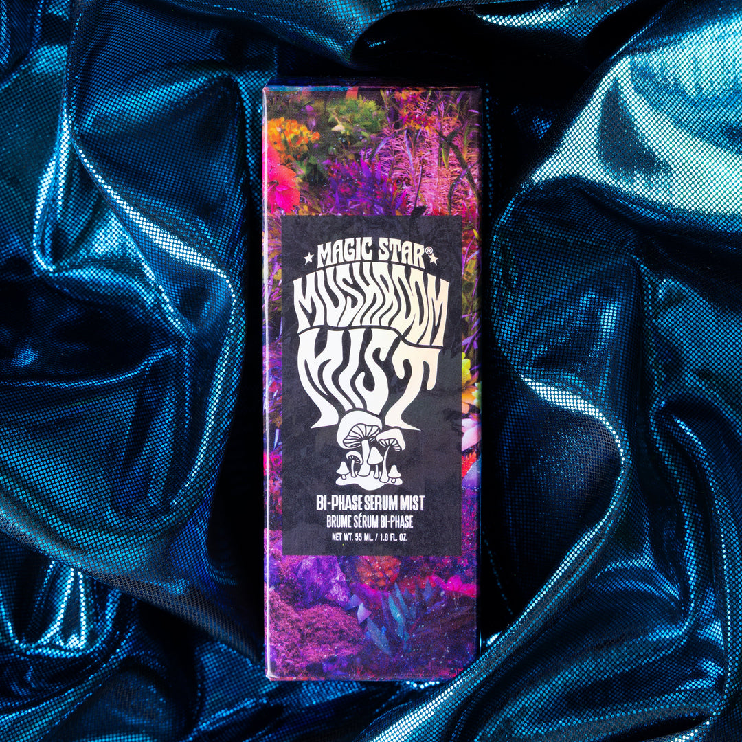 Mystic Dust product packaging on a blue satin background